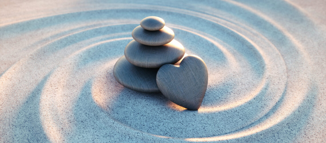Stack,Of,Dark,Stones,With,Heart,In,Sand,Waves,-